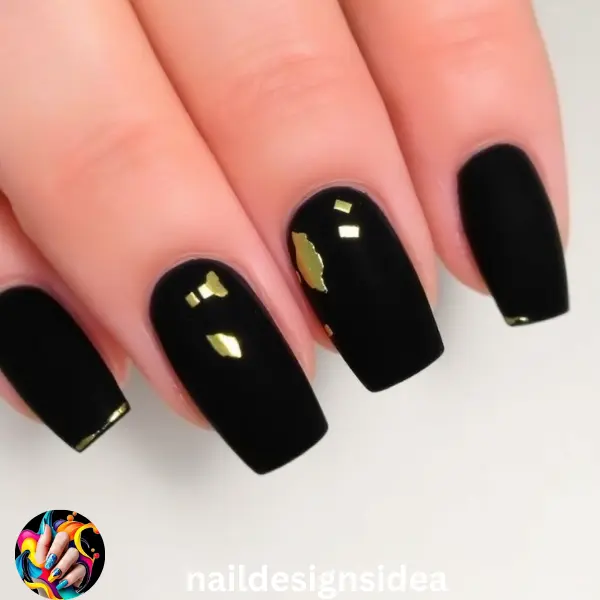 Black velvet nails exude a luxurious feel, and adding gold foil accents only enhances this look, creating a perfect dark Christmas vibe. 