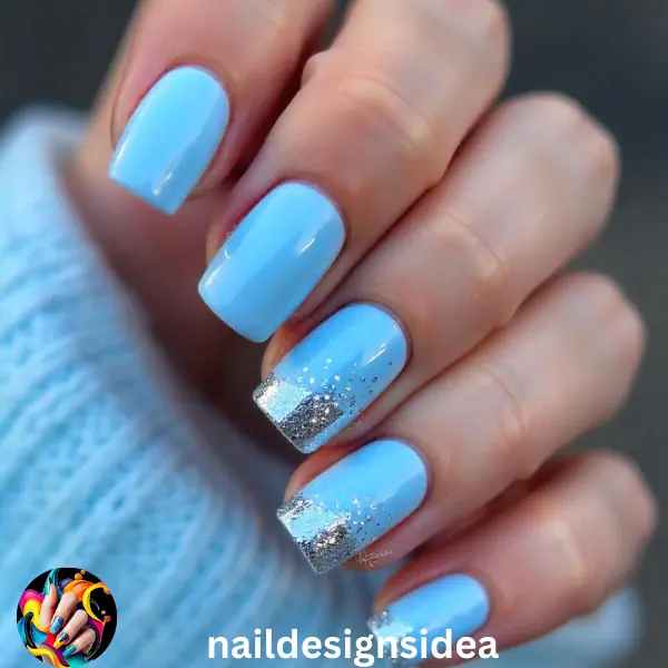 For a cool and frosty vibe, opt for icy blue nails with glitter accents. Choose a soft, pastel blue as your base color and add a layer of silver glitter polish over the top