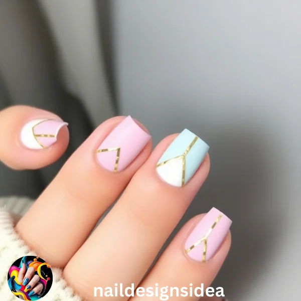 Geometric shapes like triangles, lines, and squares can add a contemporary edge to your sugar cookie-inspired manicure. 